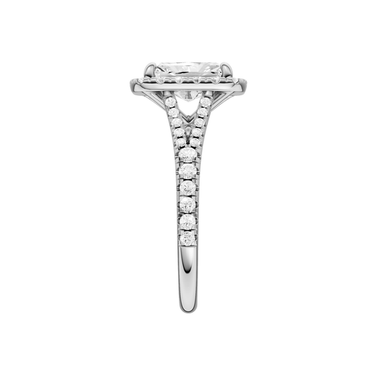A side view of the Radiant cut diamond engagement ring in 14k white gold with a diamond band and halo setting