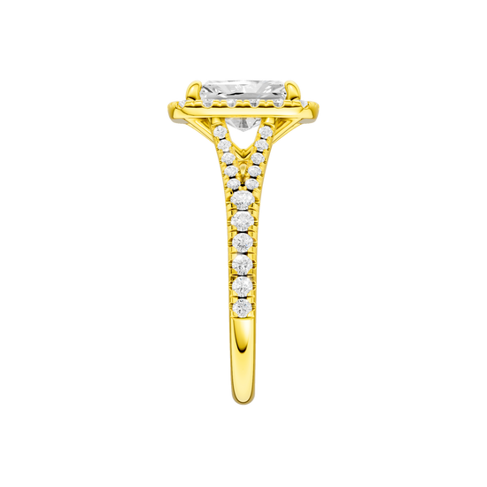 A side view of the Radiant cut diamond engagement ring in 14k yellow gold with a diamond band and halo setting