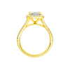 A profile view of the Radiant cut diamond engagement ring in 14k yellow gold with a diamond band and halo setting