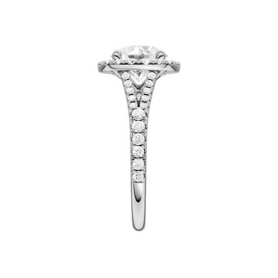 A side view of the Round cut diamond engagement ring in platinum with a prong diamond band and split setting