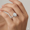 Elongated cushion cut diamond engagement ring in 14k white gold with a prong diamond band and split setting on a hand