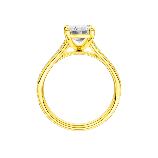 A profile view of the Emerald cut diamond engagement ring in 14k yellow gold with a diamond channel band and split setting