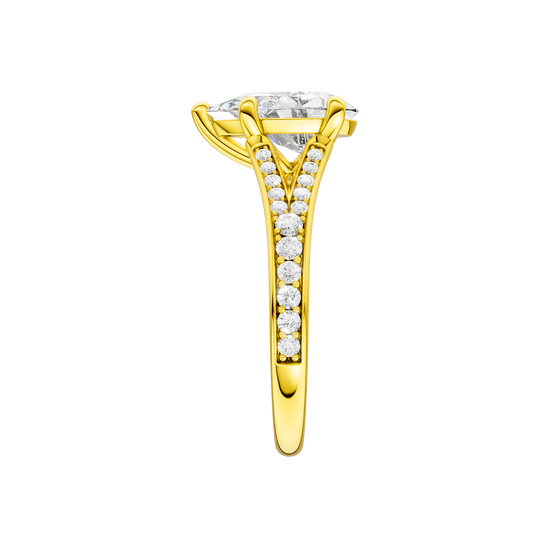 A side view of the Pear cut diamond engagement ring in 14k yellow gold with a diamond channel band and split setting