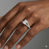 Radiant cut diamond engagement ring in 14k white gold with a diamond channel band and split setting on a hand
