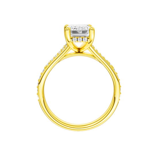 A profile view of the Emerald cut diamond engagement ring in 14k yellow gold with a diamond channel band and split setting