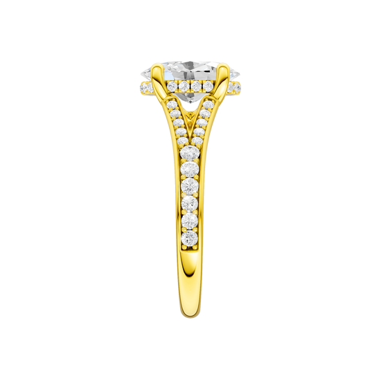 A side view of the Oval cut diamond engagement ring in 14k yellow gold with a channel band and hidden halo setting