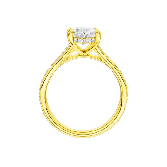A profile view of the Oval cut diamond engagement ring in 14k yellow gold with a channel band and hidden halo setting