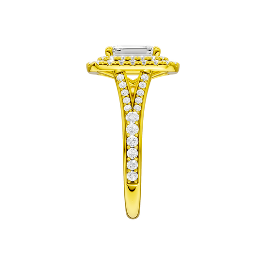 A side view of the Emerald cut diamond engagement ring in 14k yellow gold with a channel band and double halo setting
