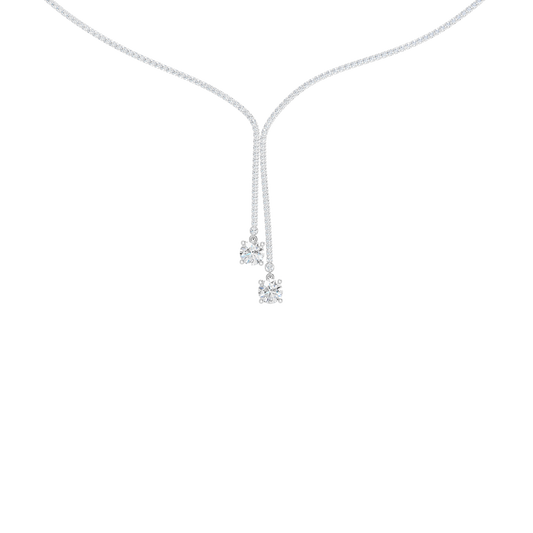 A close-up of the delicate 14K white gold diamond lariat Y necklace (Versailles Plunge) on a light background.