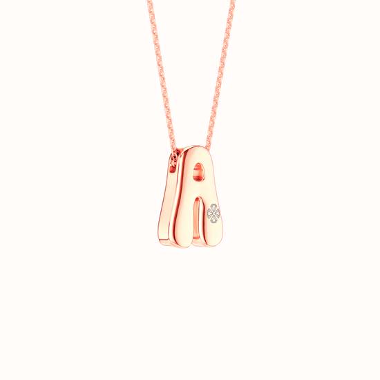 Side view of the Amorati Diamond Bubble Pop Necklace in 14K rose gold. Initial pendant necklace featuring the letter 'A' adorned with a small lab grown diamonds, suspended from a delicate rose gold chain against a solid white background.