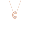 A rose gold letter 'C' pendant necklace with three small clear gemstones, suspended from a delicate matching chain against a solid white background.