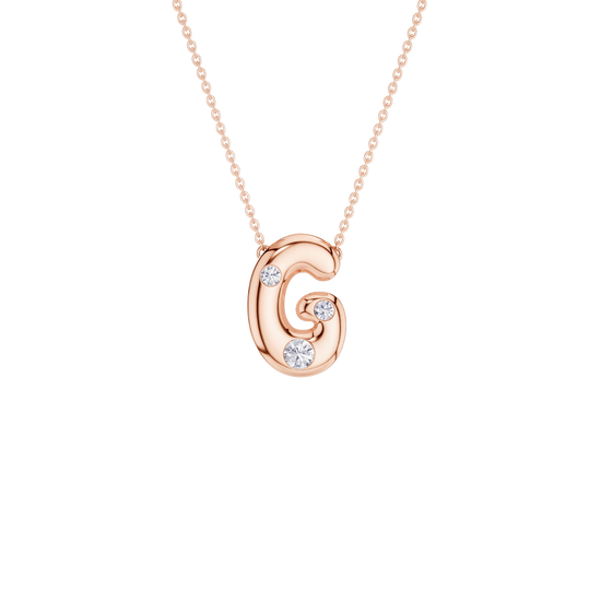 A rose gold initial necklace featuring the letter 'G' pendant adorned with three clear round-cut gemstones, suspended from a delicate matching chain against a solid white background.