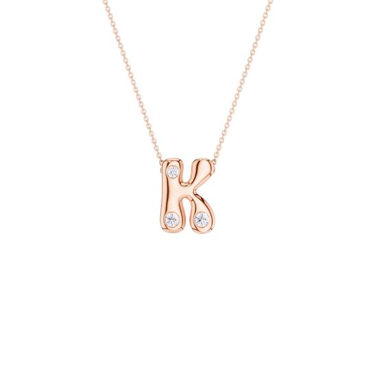 A delicate gold chain necklace with a small flower-shaped pendant featuring a central clear gemstone surrounded by small clear stones, set against a plain white background.