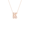 A delicate gold chain necklace with a small flower-shaped pendant featuring a central clear gemstone surrounded by small clear stones, set against a plain white background.