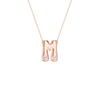 A rose gold initial pendant necklace featuring the letter 'M' with two small clear gemstones at its base, suspended from a delicate rose gold chain against a solid white background.