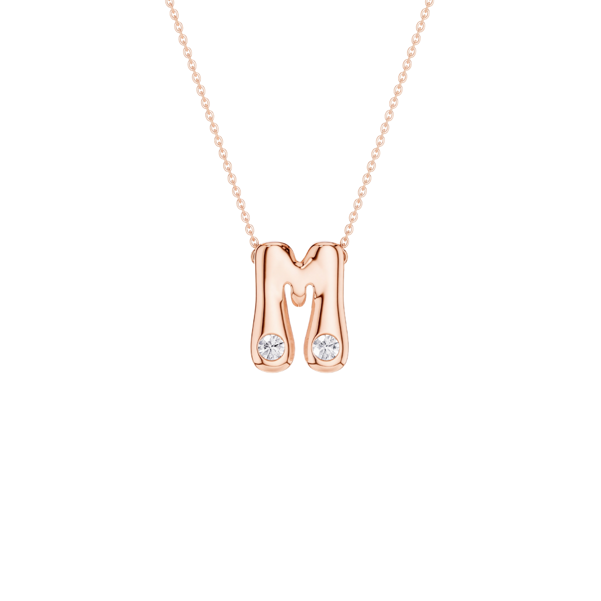 A rose gold initial pendant necklace featuring the letter 'M' with two small clear gemstones at its base, suspended from a delicate rose gold chain against a solid white background.