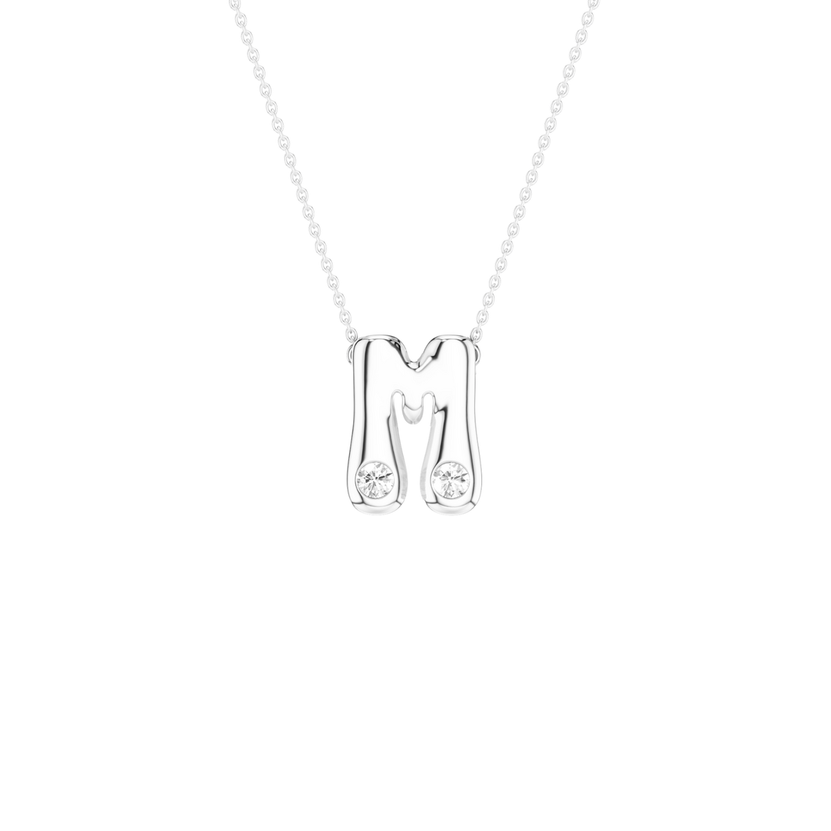 A silver initial necklace featuring the letter 'M' with two small clear gemstones set into the lower portions of the letter, suspended from a delicate silver chain against a solid white background.