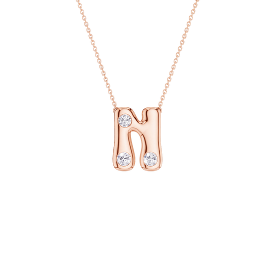 A rose gold initial necklace featuring the letter 'N' adorned with three clear round-cut gemstones, suspended from a delicate matching chain against a solid white background.