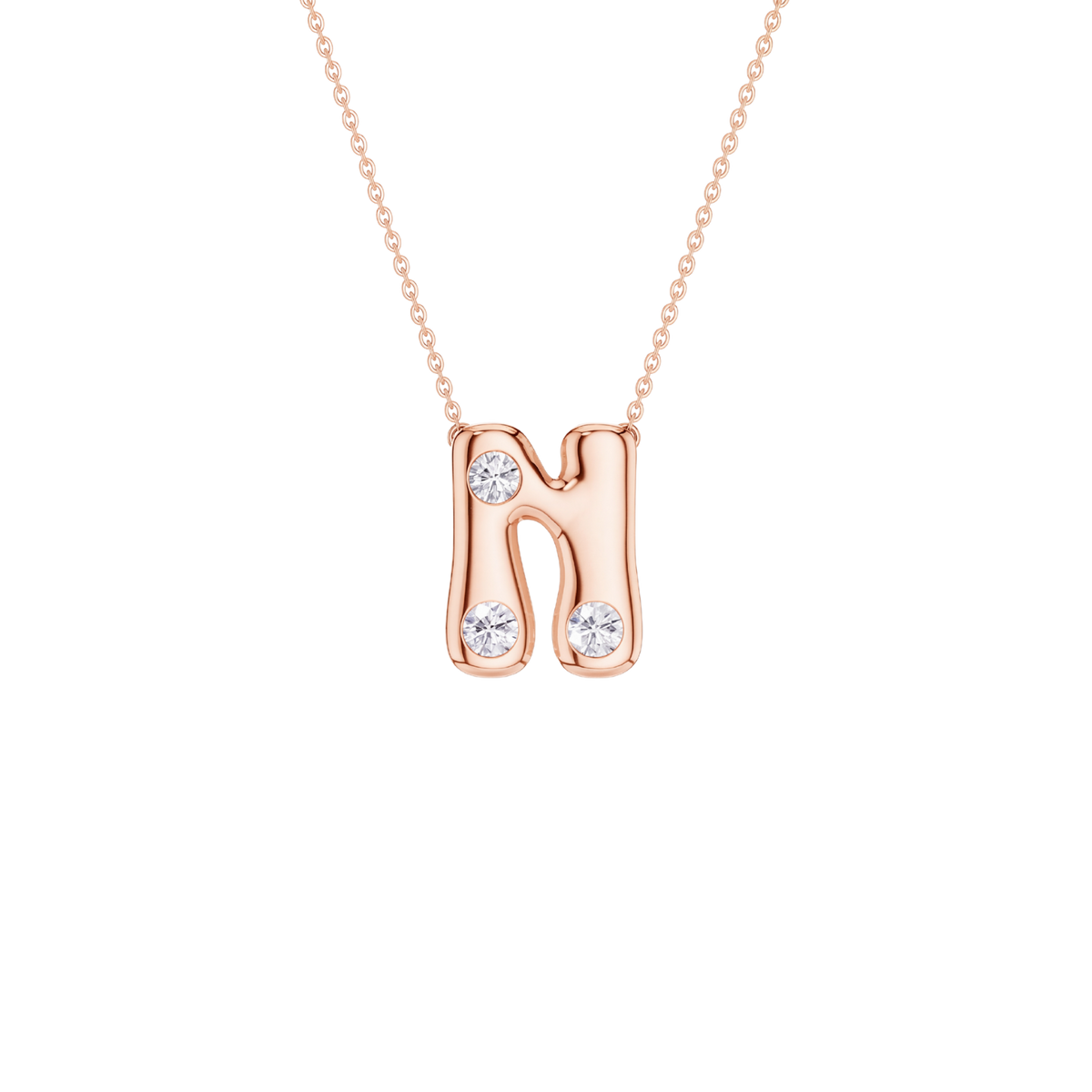 A rose gold initial necklace featuring the letter 'N' adorned with three clear round-cut gemstones, suspended from a delicate matching chain against a solid white background.
