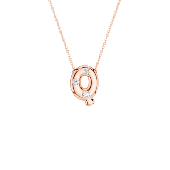 A rose gold initial necklace featuring the letter 'Q' pendant adorned with four small clear gemstones, suspended from a delicate matching chain against a solid white background.