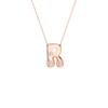 A rose gold initial necklace featuring the letter 'R' adorned with three small clear round-cut gemstones, suspended from a delicate matching chain against a solid white background.