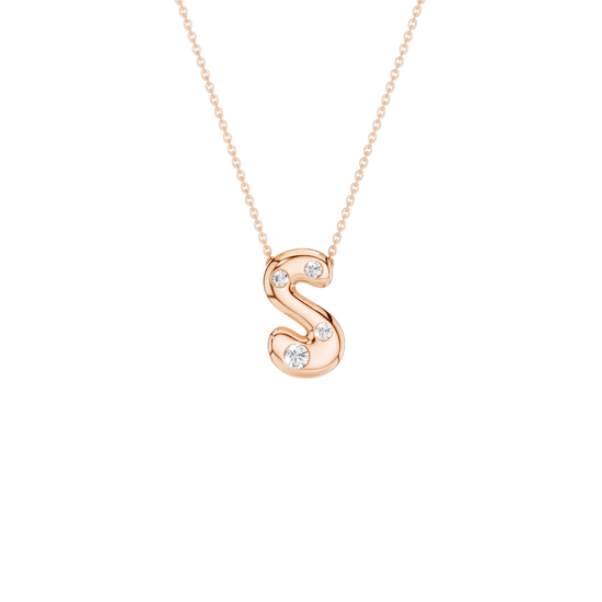 A rose gold initial pendant necklace featuring the letter 'S' adorned with three small clear gemstones, suspended from a delicate matching chain against a solid white background.