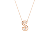 A rose gold initial pendant necklace featuring the letter 'S' adorned with three small clear gemstones, suspended from a delicate matching chain against a solid white background.
