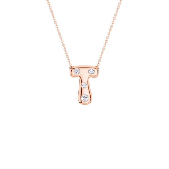 A rose gold initial necklace featuring the letter 'T' adorned with three clear round-cut gemstones, suspended from a delicate matching chain against a solid white background.