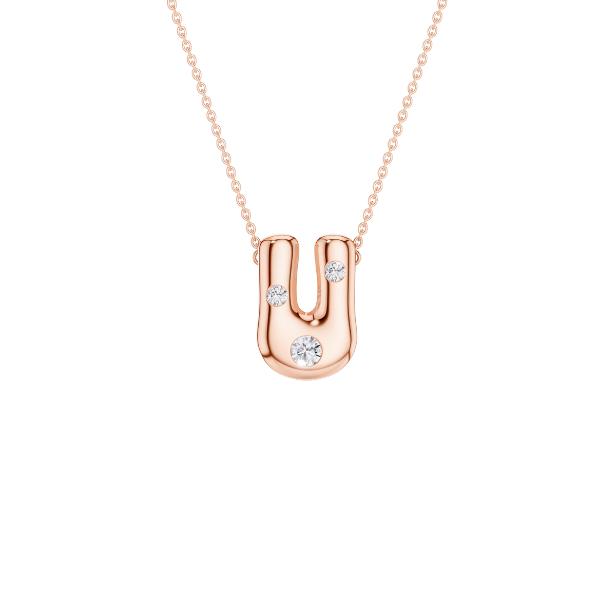 A rose gold U-shaped pendant necklace with three small clear gemstones, suspended from a delicate matching chain on a solid white background.