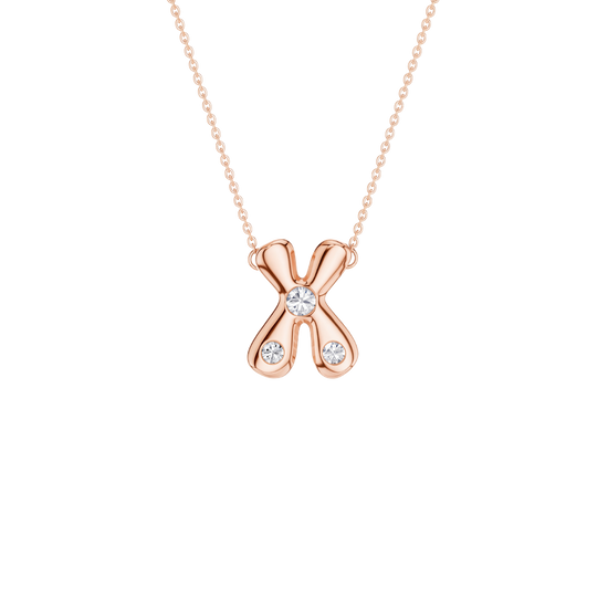 A rose gold necklace featuring an 'X' shaped pendant with three clear gemstones, set against a solid white background.