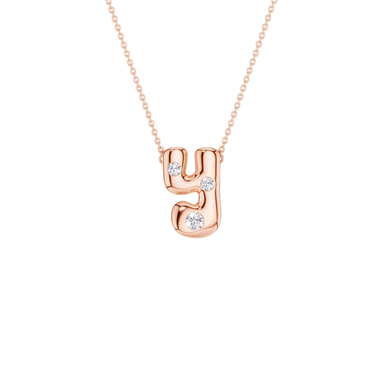 A rose gold initial necklace featuring the letter 'y' adorned with three small clear round-cut gemstones, suspended from a delicate matching chain against a solid white background.