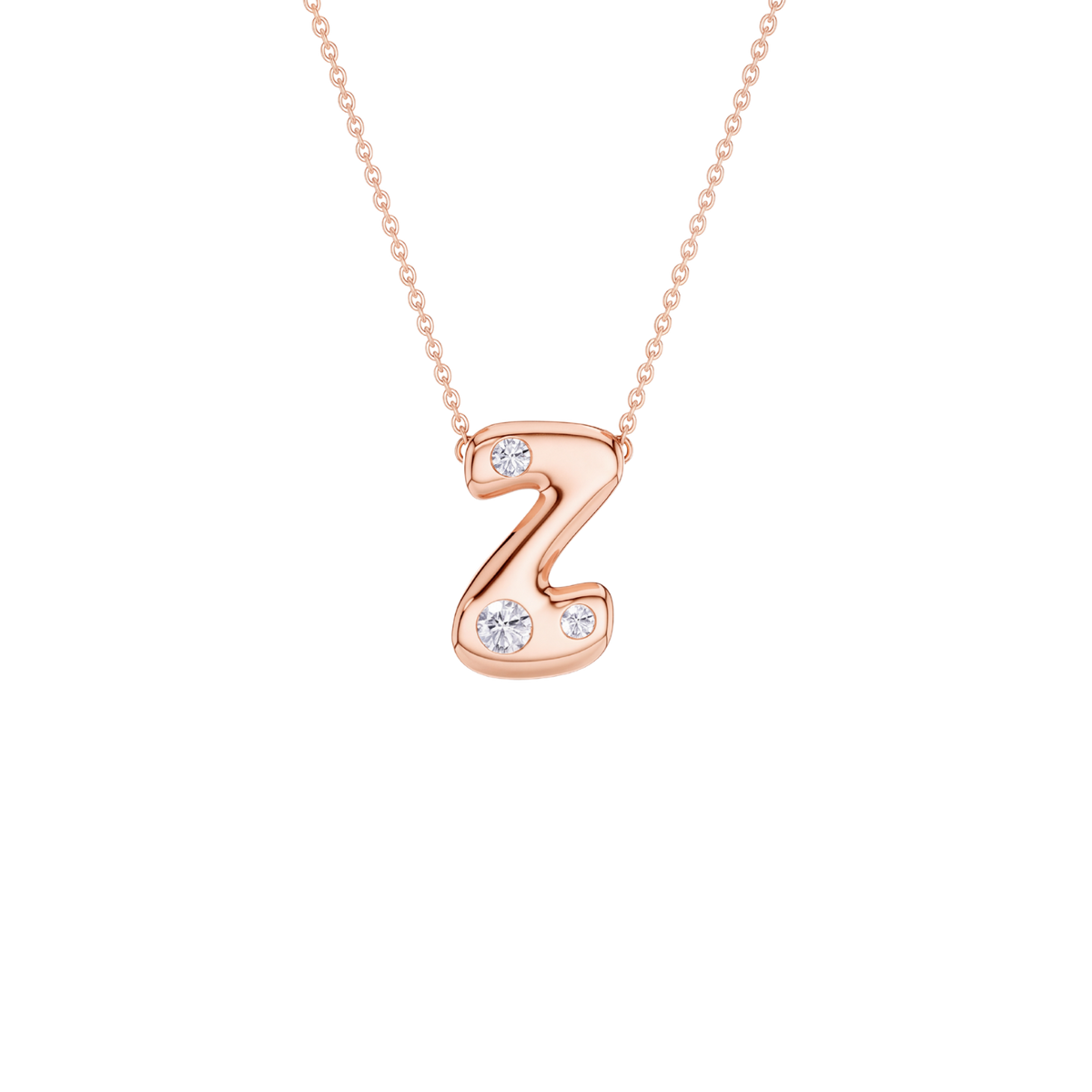 A rose gold initial necklace featuring the letter 'Z' adorned with three small clear gemstones, suspended from a delicate matching chain against a solid white background.