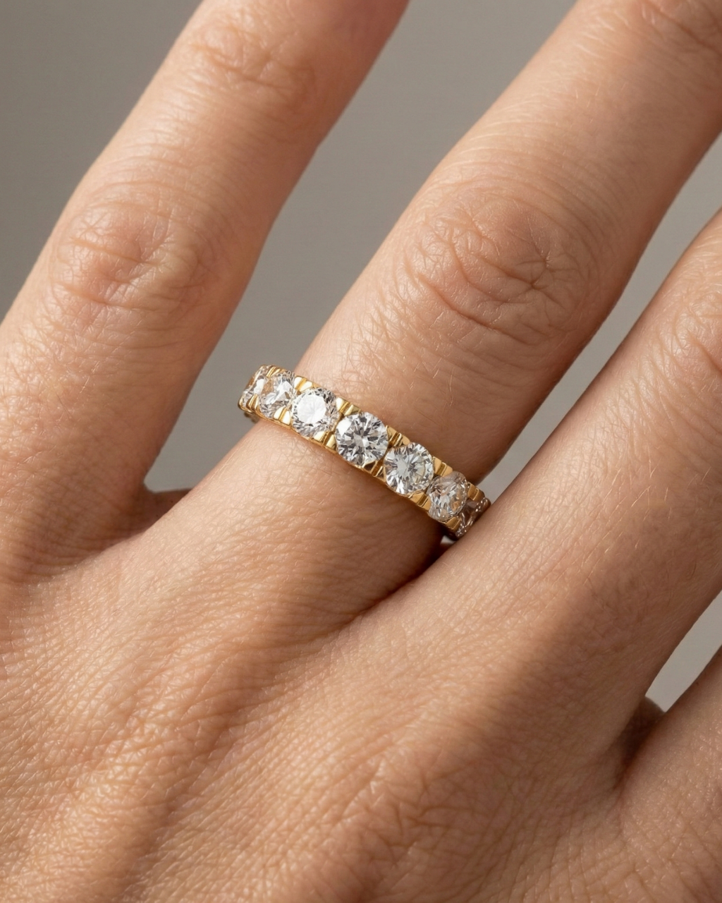 A magnificent 14k yellow gold eternity band featuring a continuous circle of 4.0 total carats of brilliant round-cut lab-grown diamonds on hand.