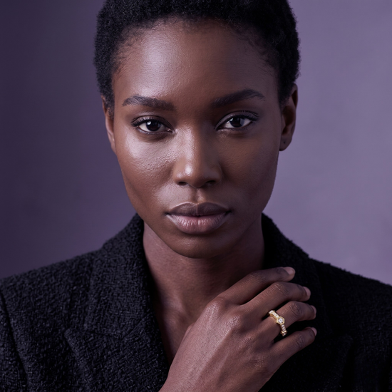 Crafted in radiant yellow gold, this modern ring features brilliant stones set in striking hexagonal bezels, complemented by a delicate pavé band. Its gently arched silhouette is perfect for seamless stacking or making a sophisticated standalone statement.