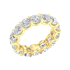 An angled view of a 14K yellow gold ring, showcasing the seamless brilliance of the bezel-set jewels.