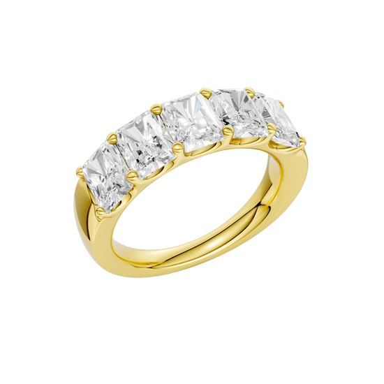 An angled view of a 14K yellow gold wide band ring, showcasing the clean, bold lines of the tapered diamonds.