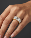 Lifestyle view of a model wearing a heavy-carat 14k yellow gold eternity ring featuring exceptionally large, vertically set emerald-cut diamonds.