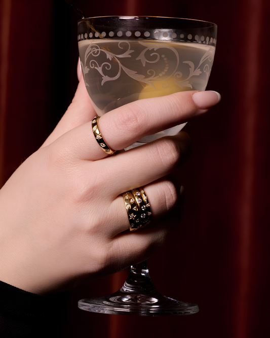 Solid 14K Gold Star Studded Diamond Dome Ring anchored in a triple-ring stack from the Amorati F O U R T E E N T H Collection. The high-contrast shot showcases the vibrant gold saturation and E-F VS+ diamond fire across the ring and pointer fingers. 3.45g of weighted luxury engineered for a high-performance lifestyle. Includes Insured Free Shipping.