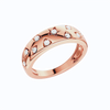 A rose gold band ring featuring rows of stars and other shapes, each set with a small white round lab grown diamond, shown on a plain white background.