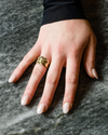 A lifestyle view of the Fourteenth Collection rose gold star studded diamond ring, highlighting sculpted star-shaped bezel settings and round diamonds embedded into a substantial, polished band.