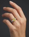 Lifestyle angled view of 4.66 Cttw Soleil Elongated Cushion Canary Yellow & White Trilogy Engagement Ring with IGI Certified 4.0ct  VS+ Vivid center lab grown diamond and .66 cttw of VS+ E-F diamond triangle side stones.