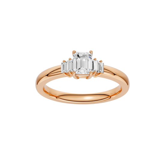 A top-down view of a 14K rose gold ring with a central rectangular jewel and two smaller round gems on the sides.