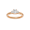 A top-down view of a 14K rose gold ring with a central rectangular jewel and two smaller round gems on the sides.