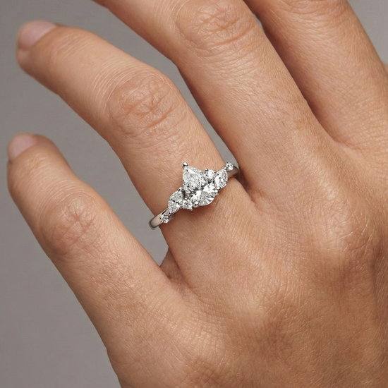 An angled view of a 14K yellow gold ring, showcasing the brilliant arrangement of the jewels on a finger.