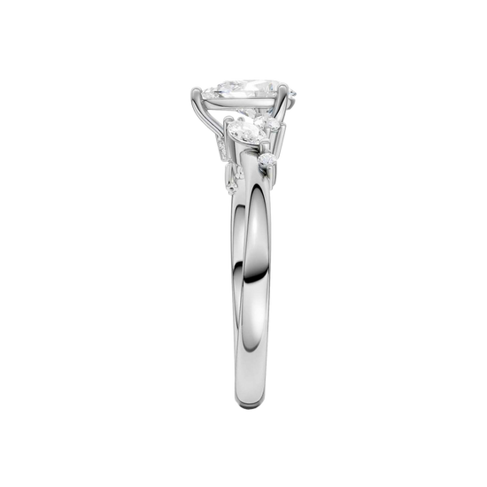 A side-profile view of a 14K white gold ring, showing the graceful setting of the three gems.