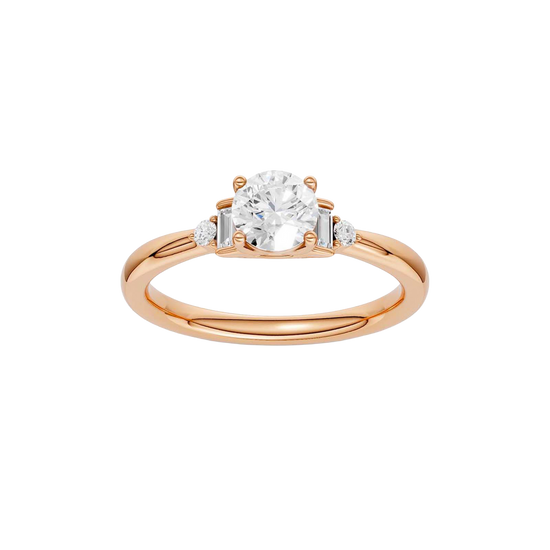 A top-down view of a 14K rose gold ring with a central round jewel and two smaller round gems on the sides.