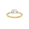 A top-down view of a 14K yellow gold ring with a central round jewel and two smaller round gems on the sides.