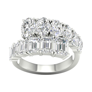 A top-down view of a 14K white gold ring with a large, asymmetrical cluster of pear and baguette diamonds.