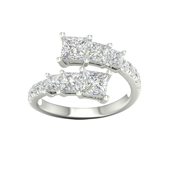 A top-down view of a 14K white gold ring with an asymmetrical cluster of princess-cut and baguette diamonds.