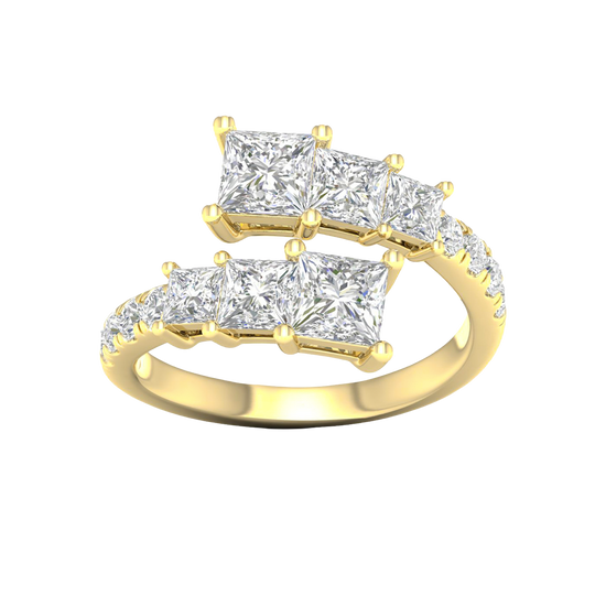 A top-down view of a 14K yellow gold ring with an asymmetrical cluster of princess-cut and baguette diamonds.